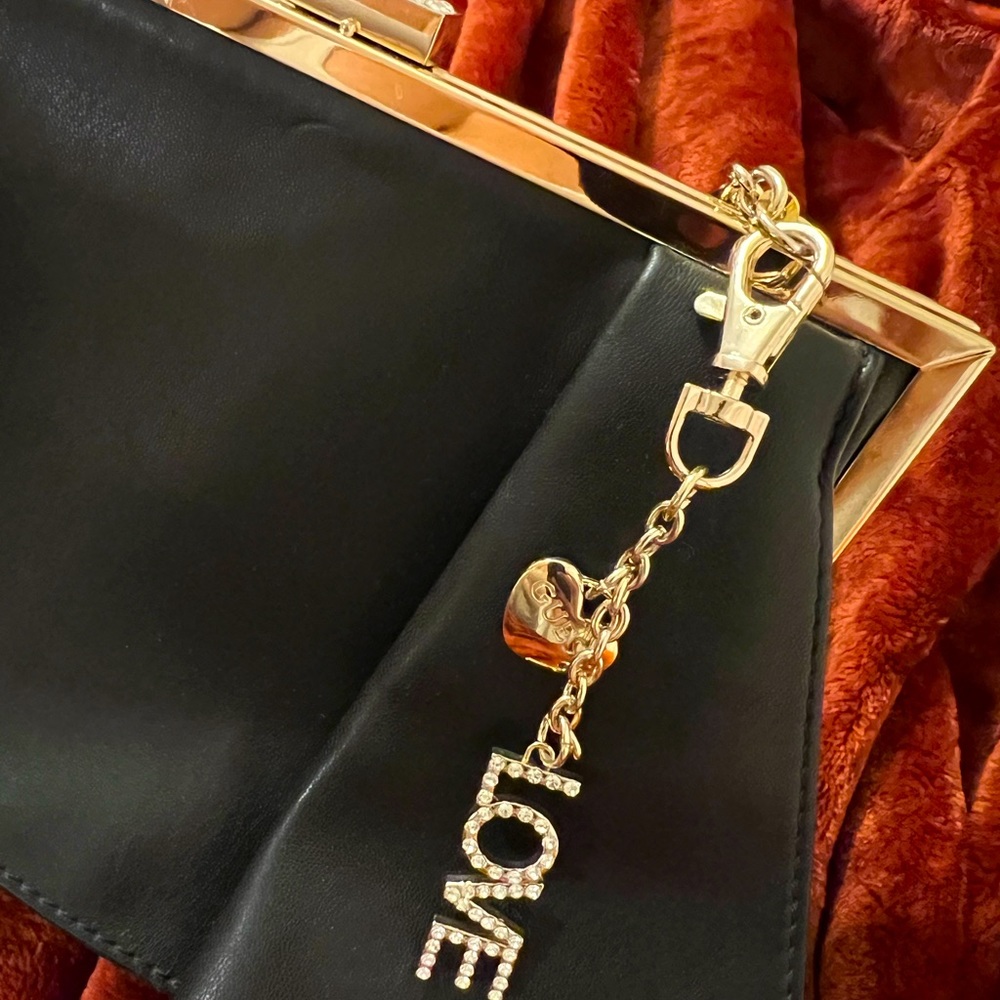 Classic Small black chain bag with gold-tone kiss lock. Rhinestone detail.